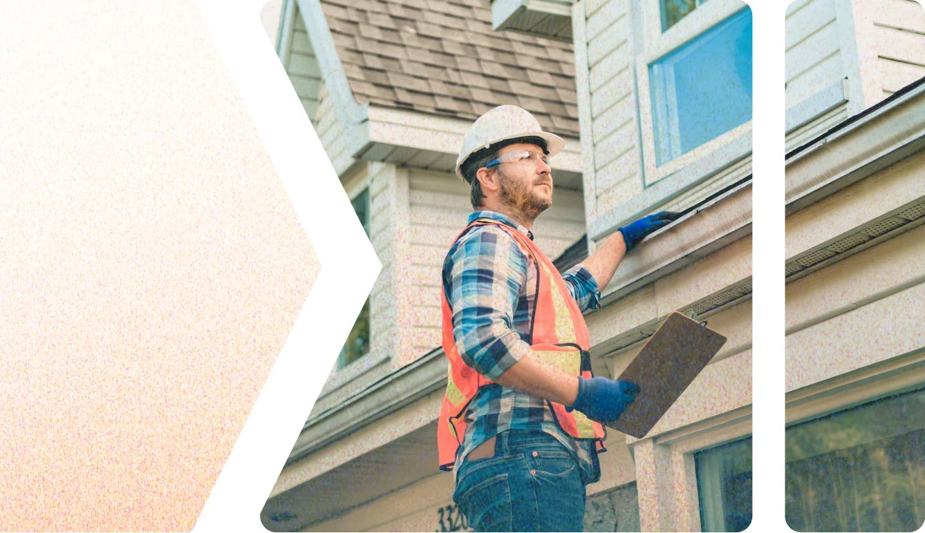 An employee of The Eavestrough Company evaluating a roofline as part of an exterior home services quote
