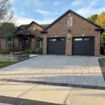 Seamless aluminum eavestroughs installed on a brick bungalow by The Eavestrough Company