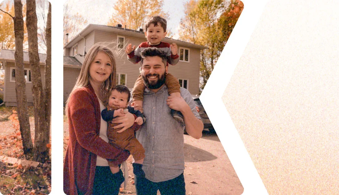 A family of four posing in front of their newly sided home