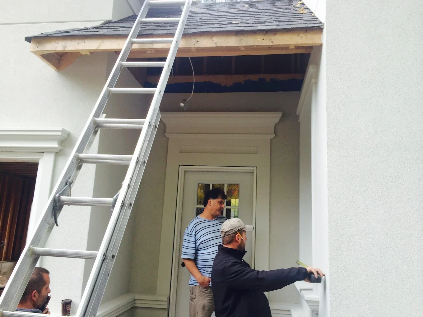 The Eavestrough Company workers installing new siding on a home, part of The Eavestrough Company's exterior renovation photo gallery