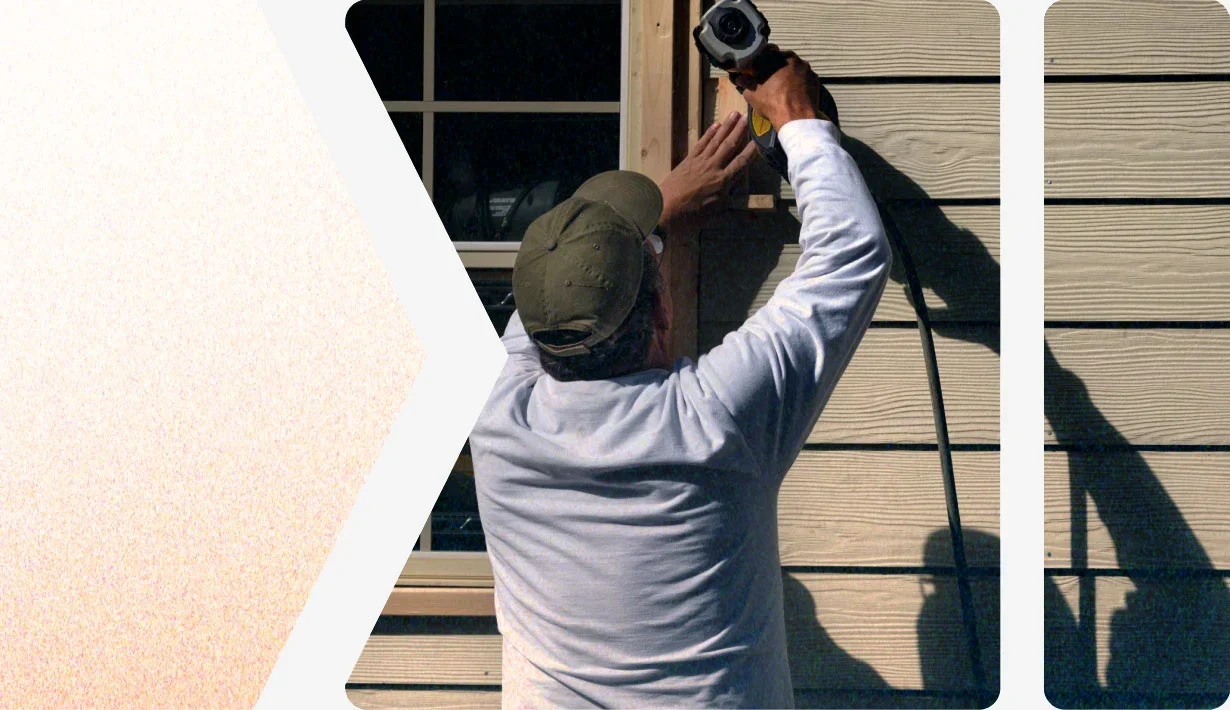 Worker installing new siding on a home