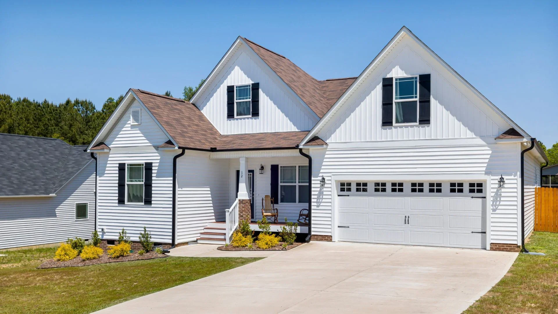 A large home with new vinyl siding installed in white colour