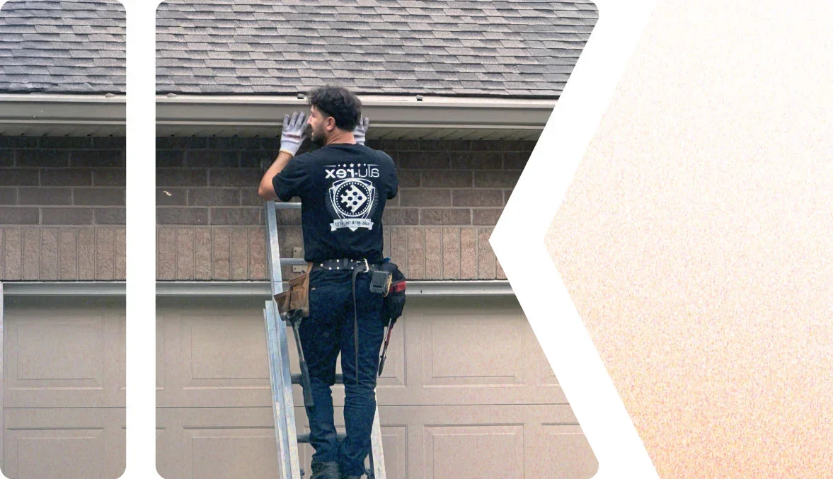 Image of a The Eavestrough Company worker doing an eavestrough replacement on a home