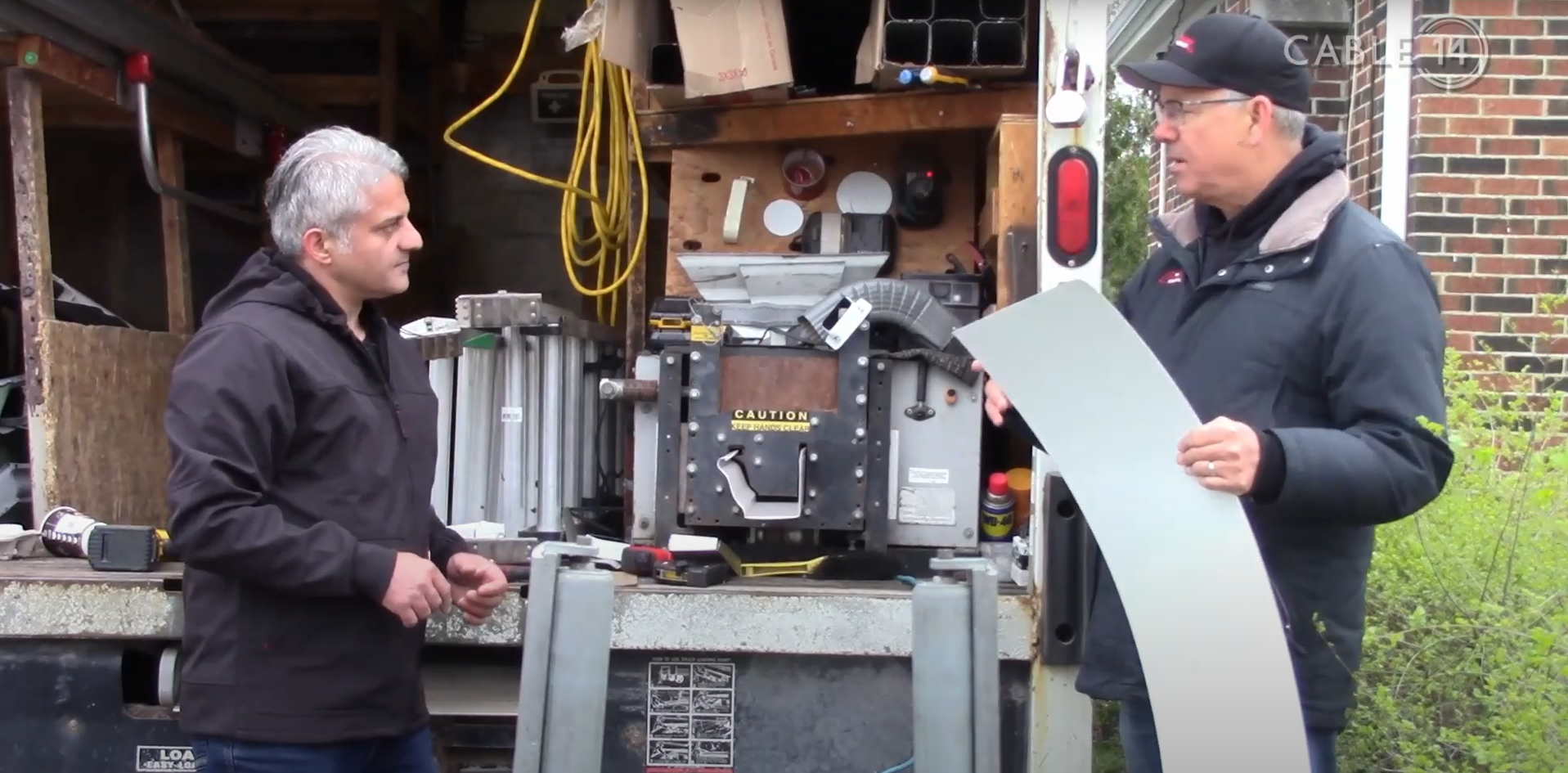 Bob and Wendle discussing the seamless aluminum coil piece and eavestrough installation cost