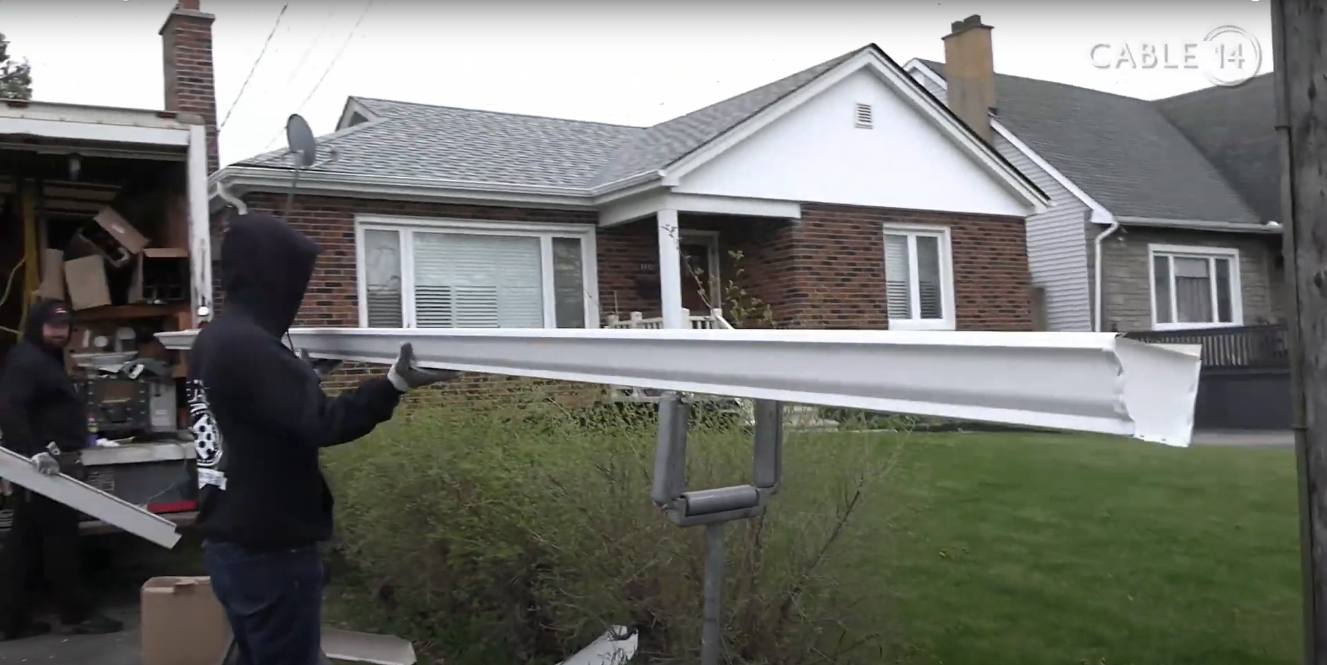 A seamless aluminum eavestrough piece being held after cutting from a gutter machine